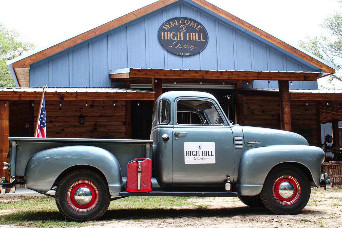 High Hill Distillery building and vintage pickup in Hallettsville